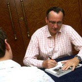 Michael autographing a copy of his first book
